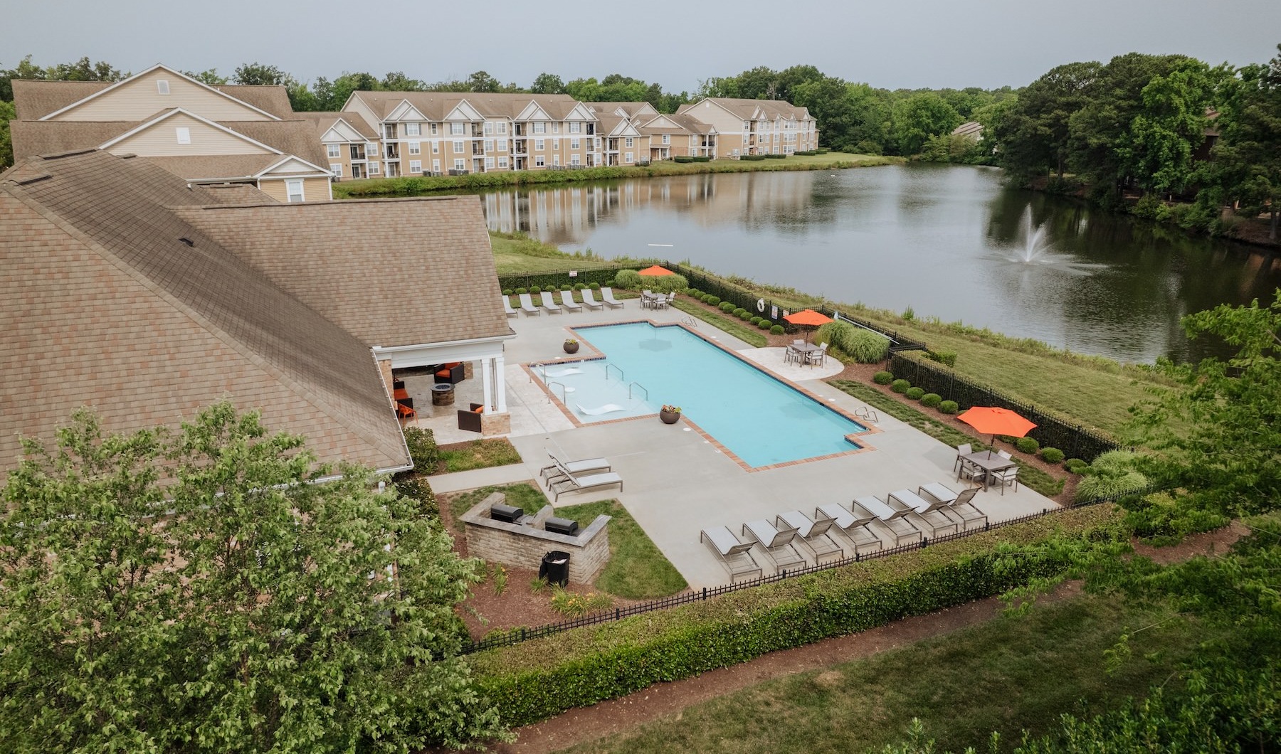 an aerial view of a pool in an apartment compelx