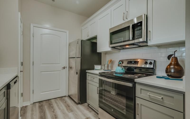 a kitchen with white cabinets