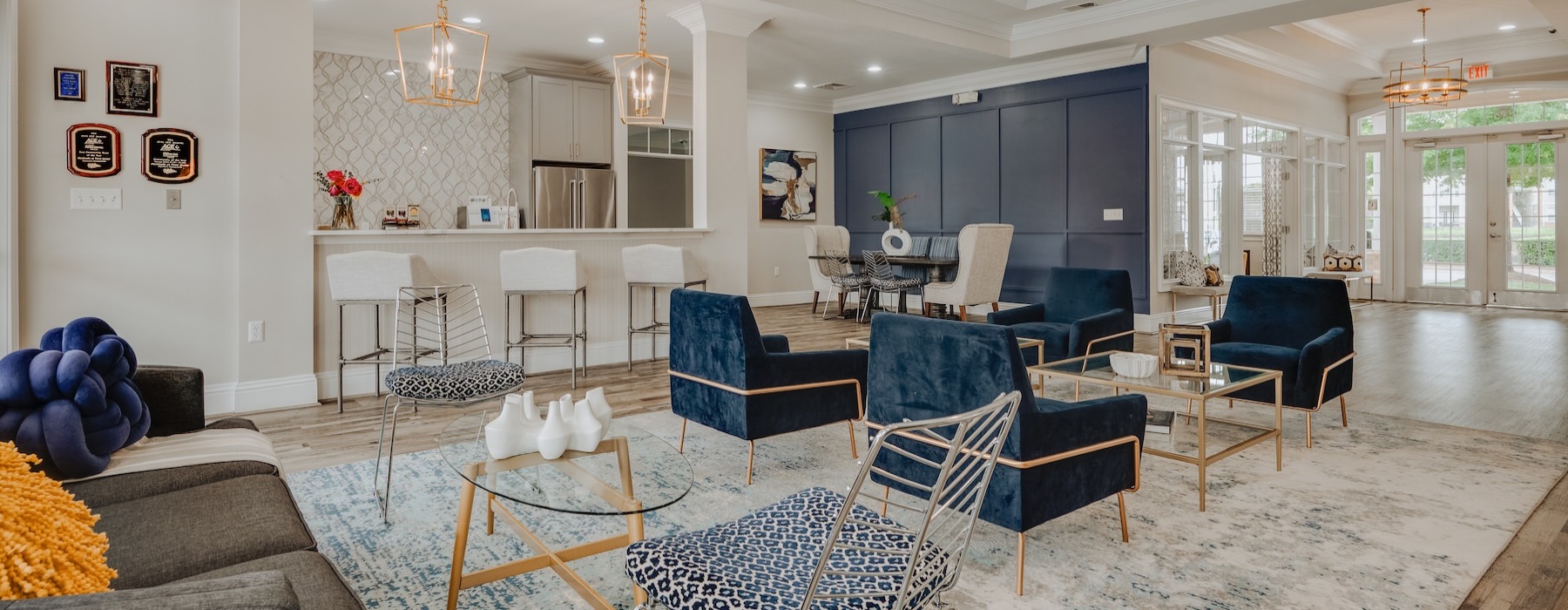 a clubroom with a couch, tables and chairs